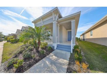 Single-story home with front porch and landscaped yard at 727 Winterside Dr, Apollo Beach, FL 33572