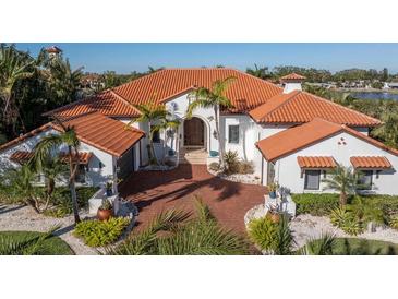 Luxury waterfront home with a brick driveway and lush landscaping at 751 34Th Ne Ave, St Petersburg, FL 33704