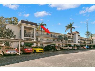 Exterior view of condo building with covered parking at 831 Maple Ct # 303, Dunedin, FL 34698