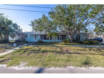 Light blue single story home with a spacious front yard at 104 159Th Ave, Redington Beach, FL 33708