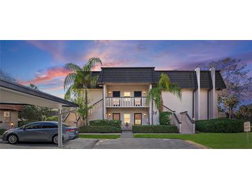 Attractive two-story condo building with lush landscaping and covered parking at 1401 Cordova Grn, Seminole, FL 33777