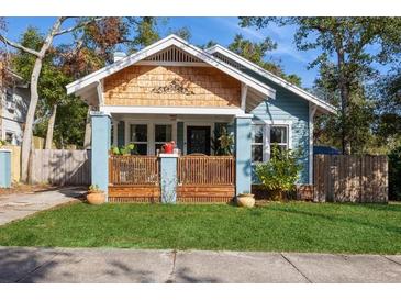 Charming bungalow with a blue exterior, wood accents, and a well-manicured lawn at 561 11Th S Ave, St Petersburg, FL 33701