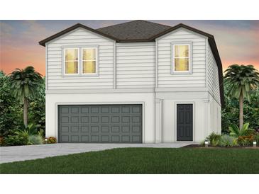 Two-story house with gray garage door and landscaping at 6211 Golden Beach Dr, Apollo Beach, FL 33572