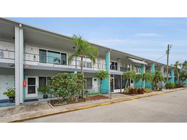 Front view of a mid-century modern condo building with teal accents at 4140 55Th N St # 1211, Kenneth City, FL 33709