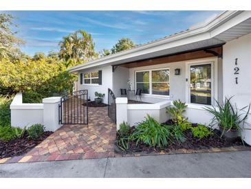 Attractive front yard with landscaping and a paved pathway leading to the entrance at 121 Live Oak Ln, Largo, FL 33770