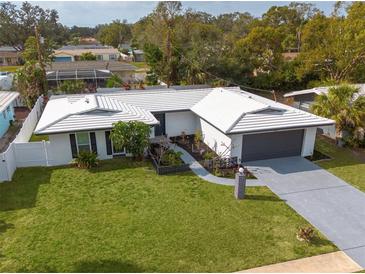 Aerial view of a renovated mid-century modern home with a large yard at 1448 S Hercules Ave, Clearwater, FL 33764