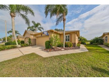Two-story house with double garage and well manicured lawn at 2019 Acadia Greens Dr # 34, Sun City Center, FL 33573