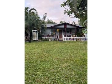 Charming single story home with a well manicured lawn and white picket fence at 225 24Th Se Ave, St Petersburg, FL 33705