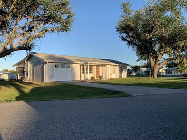 Updated ranch home with a carport and well-manicured lawn at 3066 Kingston St, Port Charlotte, FL 33952