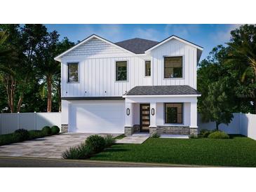 Two-story white house with gray roof, two-car garage, and landscaped yard at 3424 Ohio Ave, Tampa, FL 33611