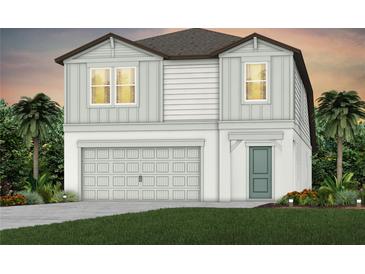 Two-story house with gray siding, two-car garage, and landscaping at 5309 Wolf Creek Dr, Apollo Beach, FL 33572