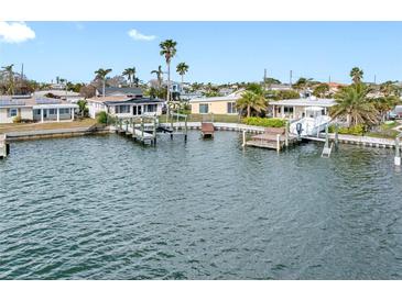 Aerial view showing waterfront home, private dock, boat lift and desirable location at 565 115Th Ave, Treasure Island, FL 33706