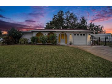 Charming ranch home with well-manicured lawn and a white garage door at 6004 1St W Ave, Bradenton, FL 34209