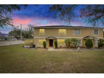 Two-story townhome with a landscaped lawn and a covered patio at 10817 Keys Gate Dr, Riverview, FL 33579