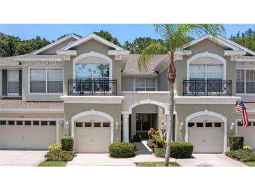 Two story townhome with attached garage and neutral color scheme at 14215 Waterville Cir, Tampa, FL 33626
