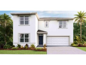 Two-story house with a two-car garage and landscaping at 2883 Gardiner Ln, Zephyrhills, FL 33541