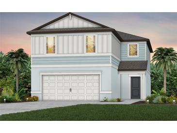 Two-story house with light blue siding, white garage door, and landscaping at 6659 Depue Dr, Wesley Chapel, FL 33545