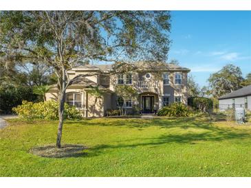 Stunning two-story home with manicured lawn and mature trees at 9244 Rhea Dr, Odessa, FL 33556