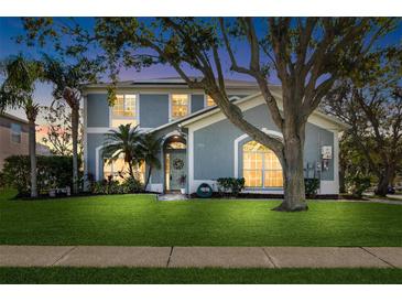 Two-story house with a manicured lawn, and a tree in front at 1600 Gray Bark Dr, Oldsmar, FL 34677