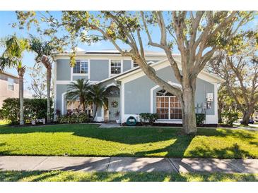 Two-story house with a manicured lawn and palm trees at 1600 Gray Bark Dr, Oldsmar, FL 34677