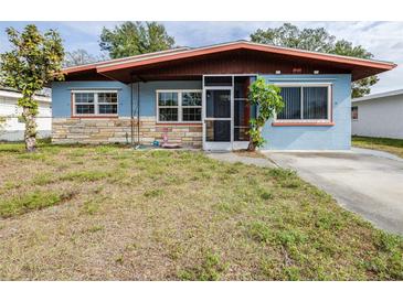 Cute blue house with stone accents and a screened porch at 1907 27Th W St, Bradenton, FL 34205