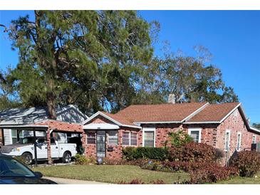 Brick home with carport and well-maintained lawn at 2504 Highland S St, St Petersburg, FL 33705