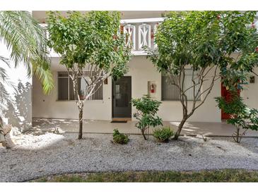 Exterior view of condo building with landscaping and individual entrances at 2630 Pearce Dr # 102, Clearwater, FL 33764