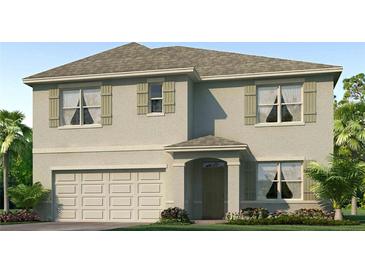 Two-story house with light beige siding, shutters, and a large garage at 35174 Valley Ridge Rd, Dade City, FL 33525