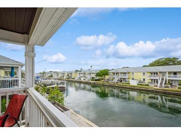 Stunning waterfront view of canal with boats and charming buildings at 5005 Coquina Key Se Dr # E, St Petersburg, FL 33705