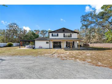 Two-story home with covered porch and large backyard at 14450 Lancer Rd, Spring Hill, FL 34610