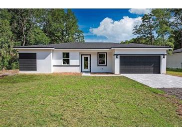 New construction home with gray accents and a two-car garage at 14469 Bulger Ave, Port Charlotte, FL 33953