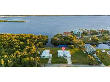 Aerial view of waterfront home with canal access and lush landscaping at 159 Danforth Dr, Punta Gorda, FL 33980