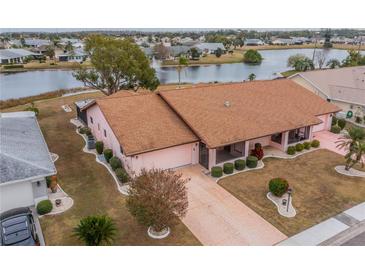 Single-story home with a large yard and water view at 1607 Dower Way, Sun City Center, FL 33573