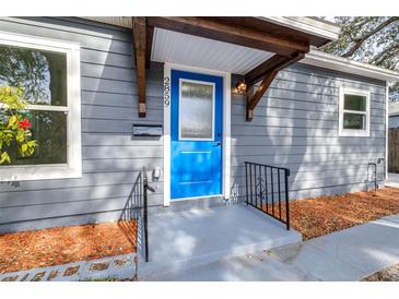 Gray house exterior with blue front door, walkway, and landscaping at 2859 38Th N Ave, St Petersburg, FL 33713