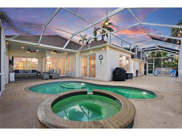 Inviting pool and spa area with covered patio and outdoor lighting at 4531 Swordfish Dr, Bradenton, FL 34208