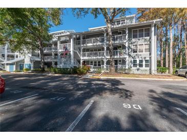 Two-story building with parking and lush landscaping at 2511 Dolly Bay Dr # 303, Palm Harbor, FL 34684