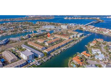 Aerial view of waterfront community with lush landscaping and private boat slips at 262 Madeira Cir, Tierra Verde, FL 33715