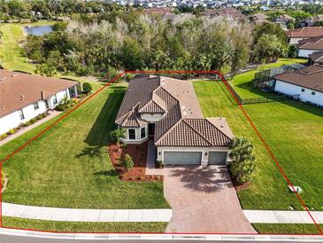 Single-story home with tile roof, large backyard, and two-car garage at 5287 Rushmere Ct, Palmetto, FL 34221