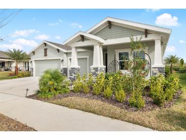 Beautiful two-story home with a three-car garage and well-manicured lawn at 6189 Hidden Branch Dr, Apollo Beach, FL 33572