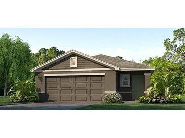 One story home with brown siding, two car garage, and landscaping at 10256 Kalamazoo Pl, Parrish, FL 34219