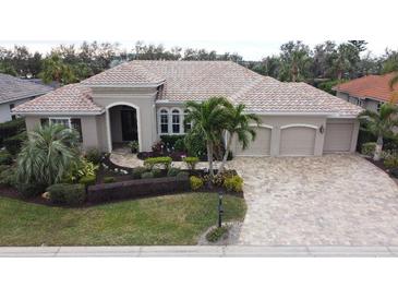 Luxury home with tile roof and three-car garage at 10626 Restoration Ter, Bradenton, FL 34212