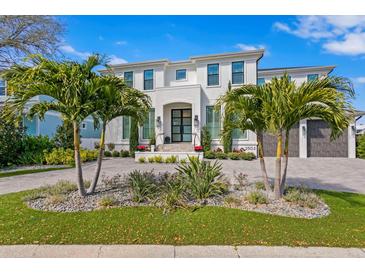 Two-story home with palm trees, and a paved driveway at 2502 S Dundee St, Tampa, FL 33629