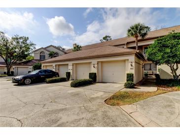 Three-car garage with ample parking space at 3000 Red Oak Court # 103, Palm Harbor, FL 34684