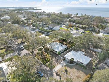 Aerial view of a single-Gathering home with a waterfront lot at 3613 S Gardenia Ave, Tampa, FL 33629