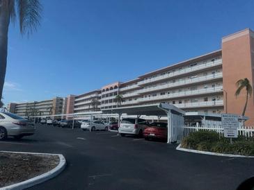 Condo building with parking and water view at 6025 Shore S Blvd # 405, Gulfport, FL 33707