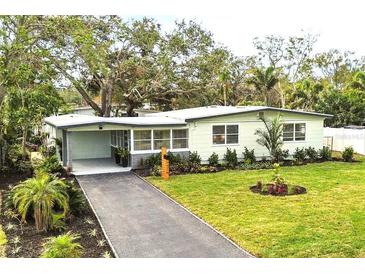 Updated mid-century home with landscaped lawn and driveway at 7326 12Th N Ave, St Petersburg, FL 33710