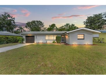 Charming ranch home with a well-manicured lawn and updated facade at 936 Lyndhurst St, Dunedin, FL 34698