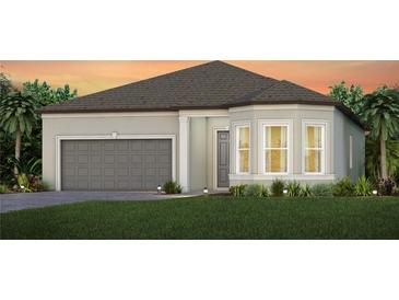 One-story home with gray siding, gray garage door, and landscaping at 9360 Barrier Coast Trl, Parrish, FL 34219