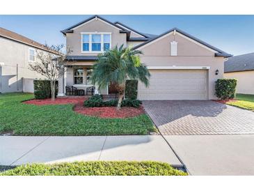 Two-story house with landscaped yard and two-car garage at 30868 Kelmin Ter, Wesley Chapel, FL 33543