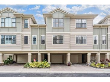 Three-story townhouses with attached garages and landscaping at 6217 Anhinga Pl, Tampa, FL 33615